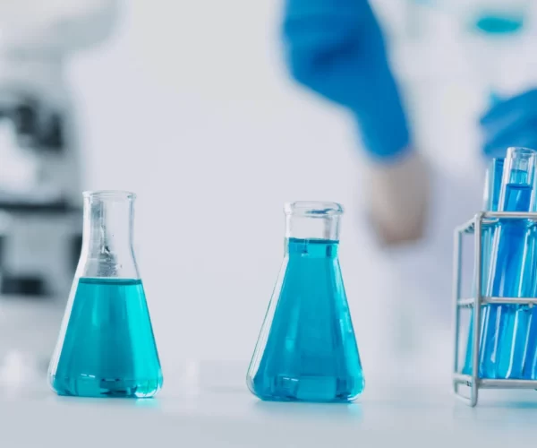 hand-scientist-with-test-tube-flask-medical-chemistry-lab-blue-banner-background