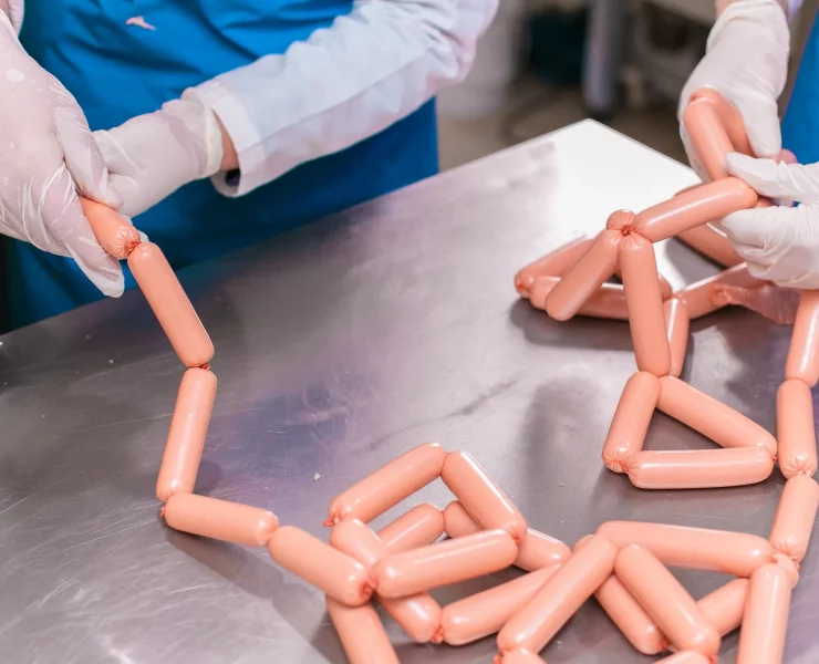 employees-sorting-produced-meat-sausages